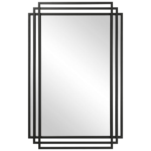 Uttermost Amherst wall mirror with a sleek, modern frame hanging on a wall, showcasing its stylish design and reflective surface.