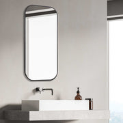 Uttermost Taft wall mirror with a sleek, modern frame, reflecting a contemporary interior design style.
