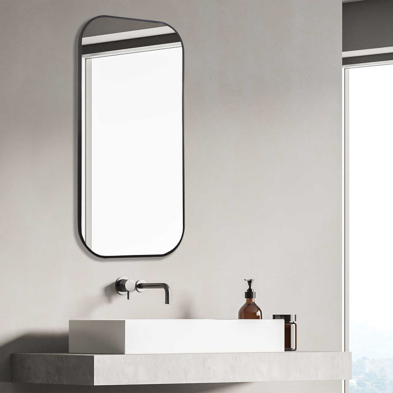 Uttermost Taft wall mirror with a sleek, modern frame, reflecting a contemporary interior design style.