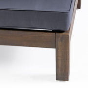 Noble House outdoor acacia wood patio arm chair with fabric cushion, showing a sturdy wooden frame and comfortable seating.
