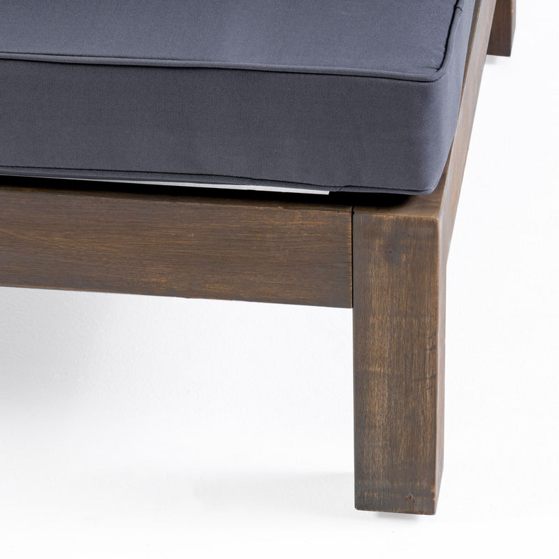Noble House outdoor acacia wood patio arm chair with fabric cushion, showing a sturdy wooden frame and comfortable seating.
