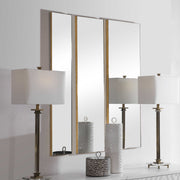 Set of three gold wall mirrors by Uttermost with modern frame designs, perfect for stylish home decor.