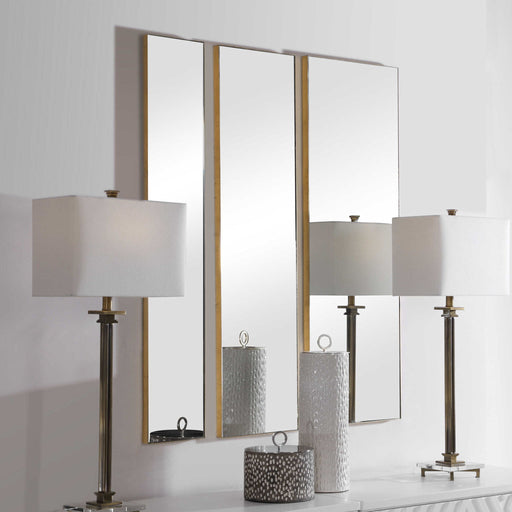 Set of three gold wall mirrors by Uttermost with modern frame designs, perfect for stylish home decor.