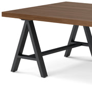 Handcrafted solid wood sawhorse coffee table by Simpli-Home with sturdy design and natural wood finish.