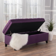 Noble House Juliana storage ottoman with birch wood legs, upholstered in soft fabric, serving as a stylish storage and seating solution.