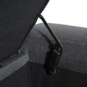 Dark gray Noble House storage ottoman with tufted top and cushioned lid, offering stylish extra seating and concealed storage.