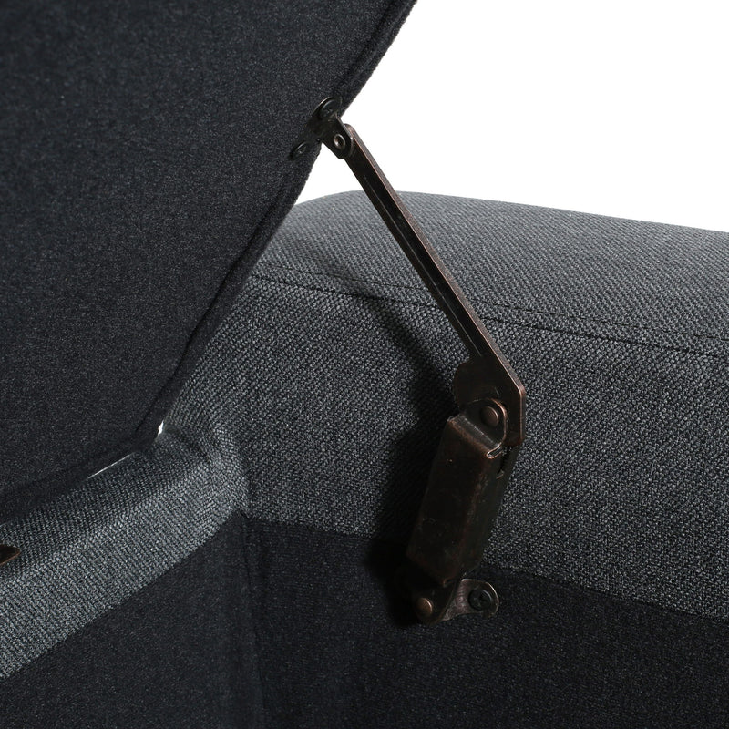 Dark gray Noble House storage ottoman with tufted top and cushioned lid, offering stylish extra seating and concealed storage.