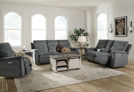 Signature Design by Ashley reclining living room set featuring plush sofas with reclining seats and overstuffed cushions.