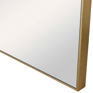 Uttermost Alexo square wall mirror with a sleek, modern frame, hanging on a wall, reflecting a room interior.