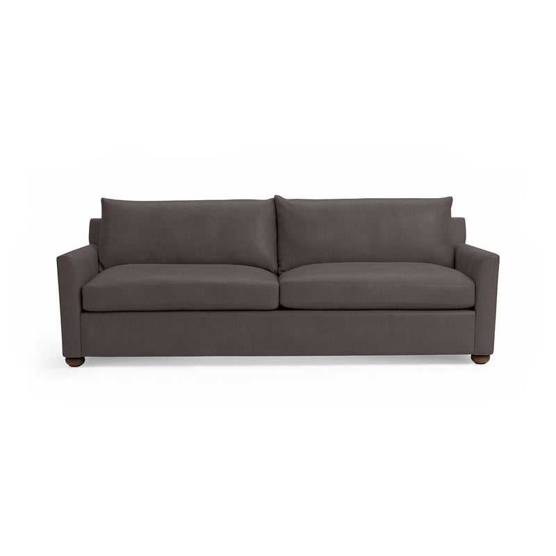 Olivia stationary sofa by Classic Home with plush fabric upholstery and a contemporary design, shown in a cozy living room setting.