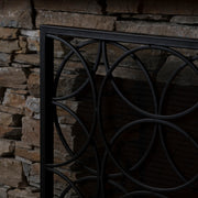 Noble House Thayer single panel iron fireplace screen with geometric design, featuring black metal construction and decorative pattern.