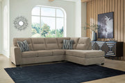 Benchcraft Olten stationary sectional sofa with plush cushions and neutral upholstery, shown in a modern living room setting.