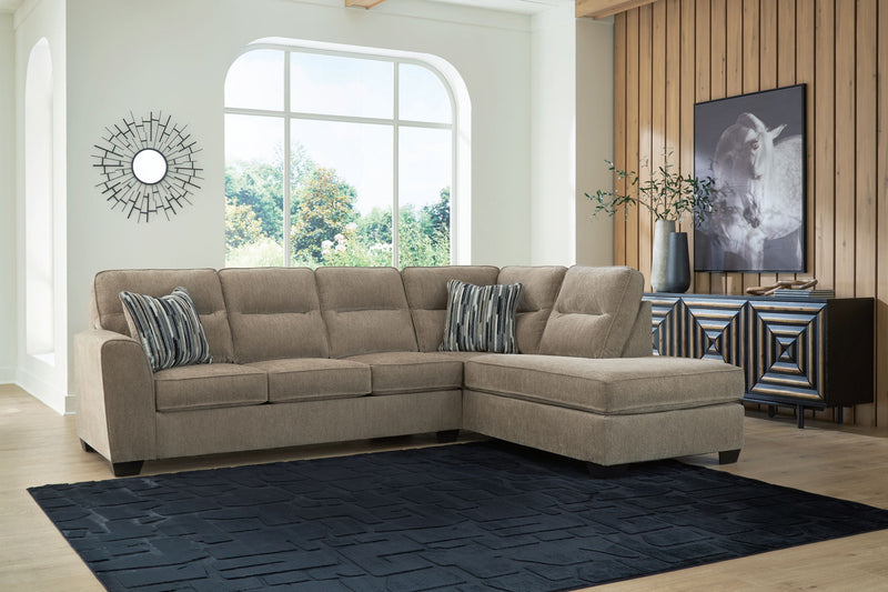 Benchcraft Olten stationary sectional sofa with plush cushions and neutral upholstery, shown in a modern living room setting.