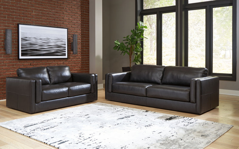 Signature Design by Ashley Amiata living room set with stationary chair and ottoman in a modern, comfortable fabric.
