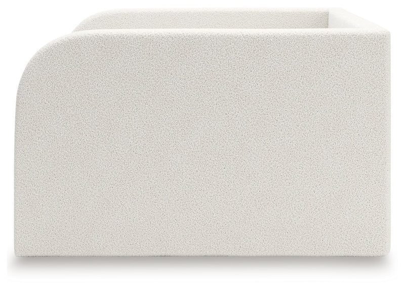 Upholstered Signature Design by Ashley® Arloster day bed with plush cushions and wooden frame, stylish and comfortable for living space.