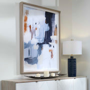 Abstract framed print in blue by Uttermost featuring modern artwork with a sleek frame and vibrant, artistic design.