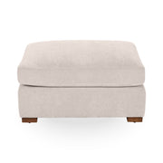 Upholstered Audrey Ottoman by Classic Home featuring a plush fabric and elegant design, perfect as a versatile accent piece.