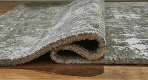 Signature Design by Ashley Valmontic area rug with intricate pattern and soft texture, suitable for living room or bedroom decor.
