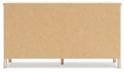 Signature Design by Ashley Cadmori six drawer dresser with sleek wood finish and modern hardware, showcasing ample storage space.