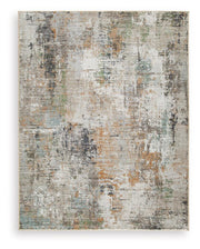 Signature Design by Ashley® Torinette area rug with a textured, patterned surface in neutral tones, suitable for living rooms or bedrooms.