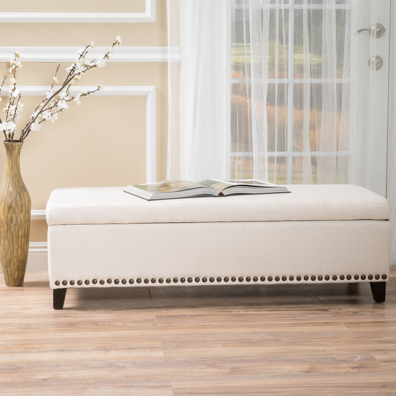 Beige upholstered storage ottoman with nailhead trim by Noble House, featuring a tufted top and built-in storage space.