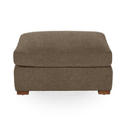 Classic Home Audrey upholstered ottoman with plush fabric and wooden legs, ideal as a versatile footrest or accent piece.