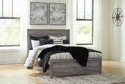 Signature Design by Ashley Bronyan panel bed with a wooden frame and clean, modern headboard in a cozy bedroom setting.