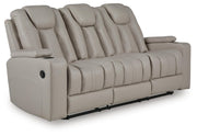 Signature Design by Ashley Elevate Edges reclining sofa with drop-down table in coin fabric, showcasing plush cushions and armrest.