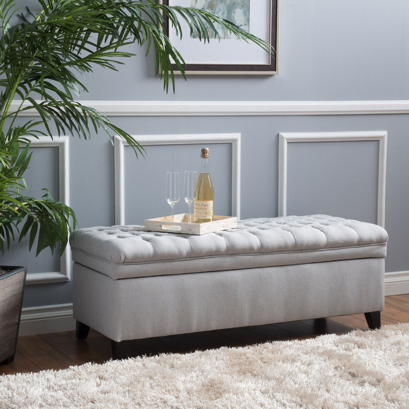 Noble House Juliana storage ottoman with beige fabric, birch wood legs, and spacious top for storage and seating.