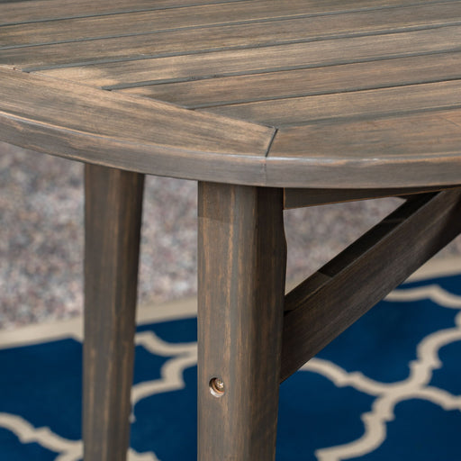 Outdoor acacia wood bar table with slat top by Noble House, featuring a sturdy design for outdoor dining and entertaining.