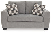 Benchcraft® Loreo stationary loveseat with plush fabric and cushioned arms, perfect for a cozy living room setting.