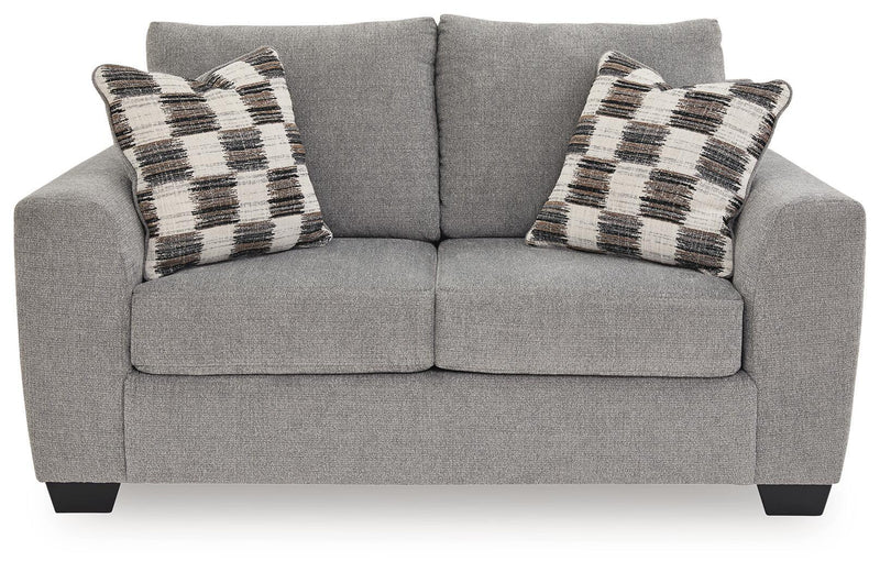Benchcraft® Loreo stationary loveseat with plush fabric and cushioned arms, perfect for a cozy living room setting.