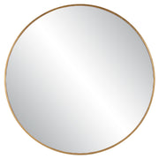 Uttermost Junius round wall mirror with a sleek metal frame, hanging on a neutral wall for modern home decor.