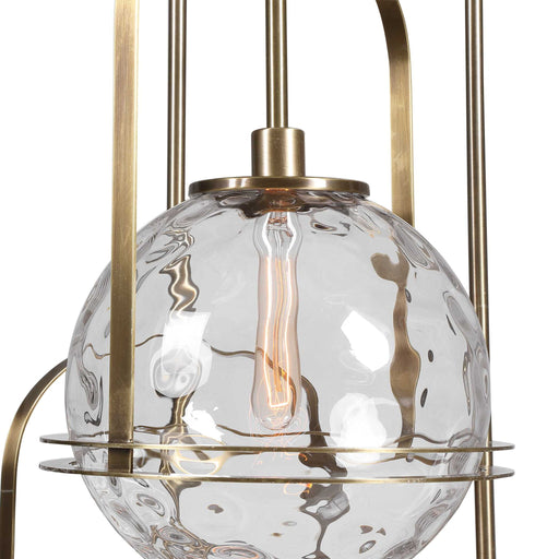 Uttermost Mimas 3-light gold pendant lighting fixture hanging with glass shades and modern design.