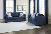 Benchcraft Evansley living room set with stationary chair and matching ottoman, upholstered in neutral fabric.