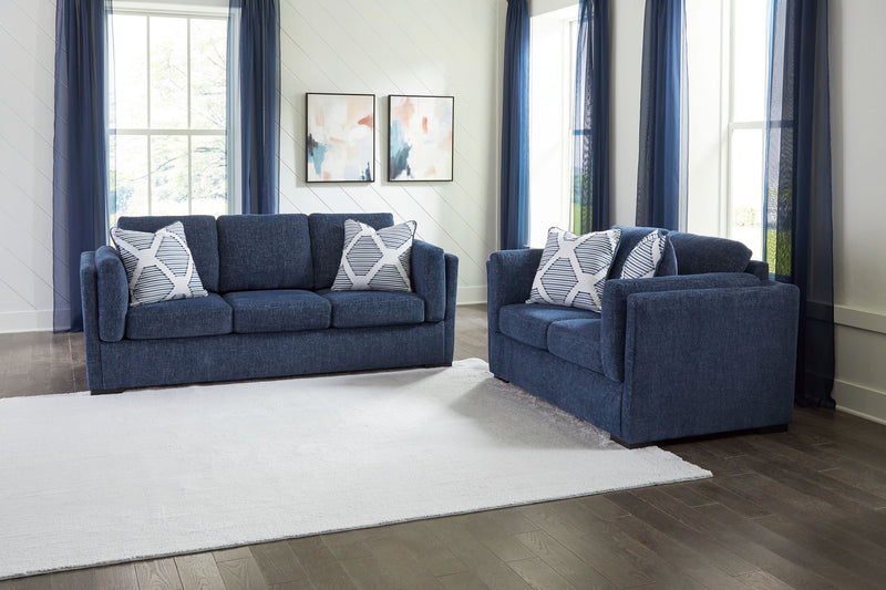 Benchcraft Evansley living room set with stationary chair and matching ottoman, upholstered in neutral fabric.