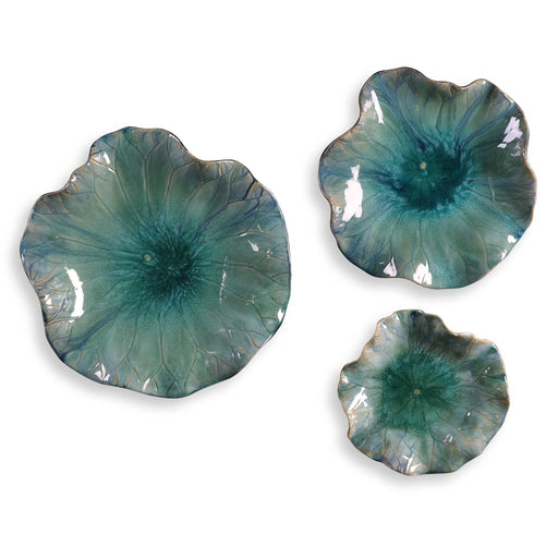 Set of three blue ceramic flower wall decor by Uttermost, showcasing detailed floral designs for elegant home decoration.