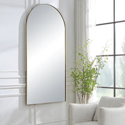 Uttermost Crosley Arch Mirror with antique brass finish, wall-mounted decorative mirror with elegant curved design.