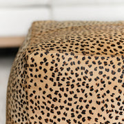 Classic Home Hide Accent Pouf in neutral fabric, round ottoman with plush cushioning for versatile seating or footrest use.
