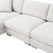 Luxe & Co. modern cloud L-shaped sectional sofa with oversized chaise, four seats, and two decorative pillows in a stylish living room setting