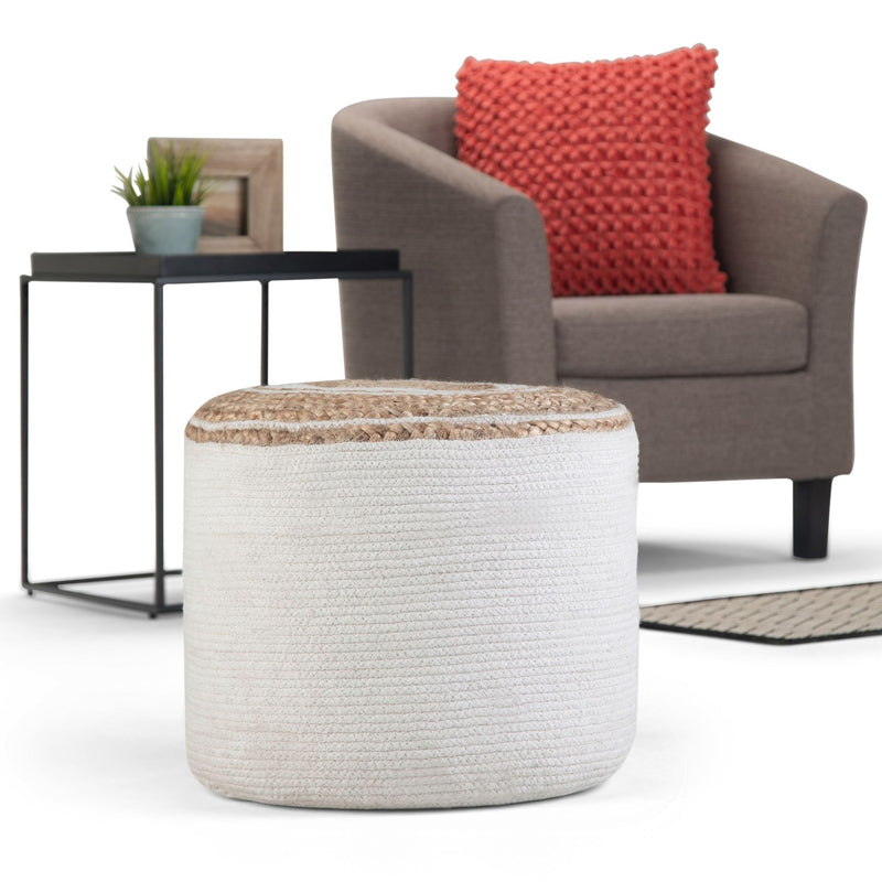 Simpli-Home Serena handcrafted round braided pouf used as an accent furniture piece in a living room setting.
