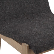 Uttermost Klemens counter stool with wooden legs and cushioned seat, shown in a modern home setting.