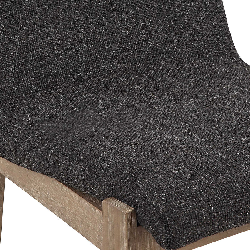Uttermost Klemens counter stool with wooden legs and cushioned seat, shown in a modern home setting.