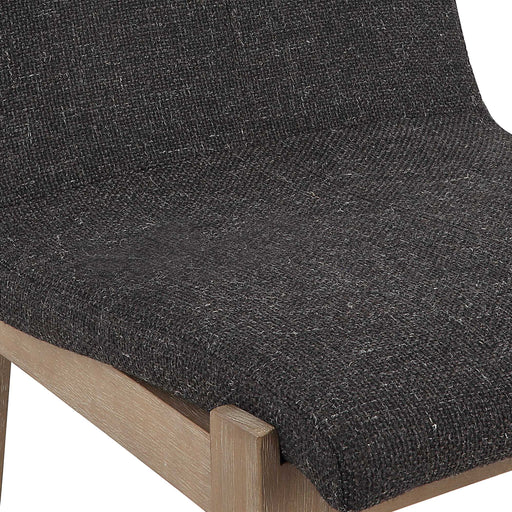 Uttermost Klemens counter stool with wooden legs and cushioned seat, shown in a modern home setting.