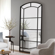 Black oversized arch accent mirror by Uttermost featuring a sleek, contemporary design with a bold, curved frame.