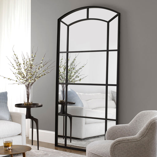 Black oversized arch accent mirror by Uttermost featuring a sleek, contemporary design with a bold, curved frame.