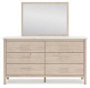 Signature Design by Ashley Cadmori six drawer dresser with a dark wood finish and modern hardware, showing the front view.