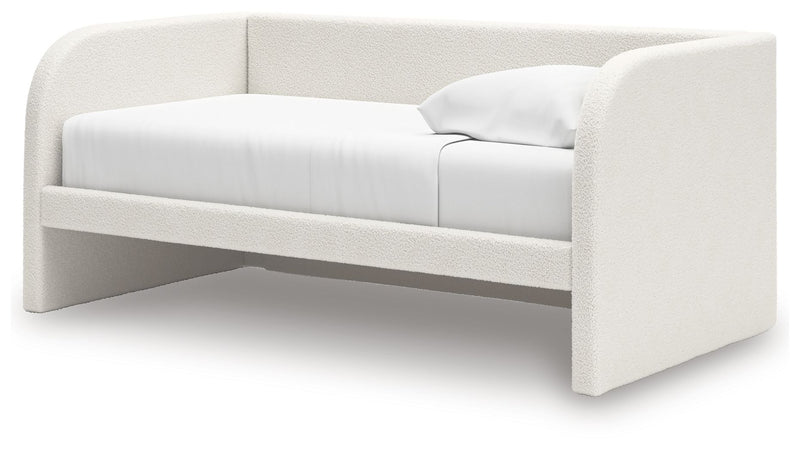 Upholstered day bed from Signature Design by Ashley®, featuring a cozy fabric-covered frame and plush cushions.