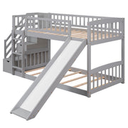 Gray DreamHaus twin over twin bunk bed with stairway, two drawers, and slide, featuring a sturdy wooden frame and safety rails.