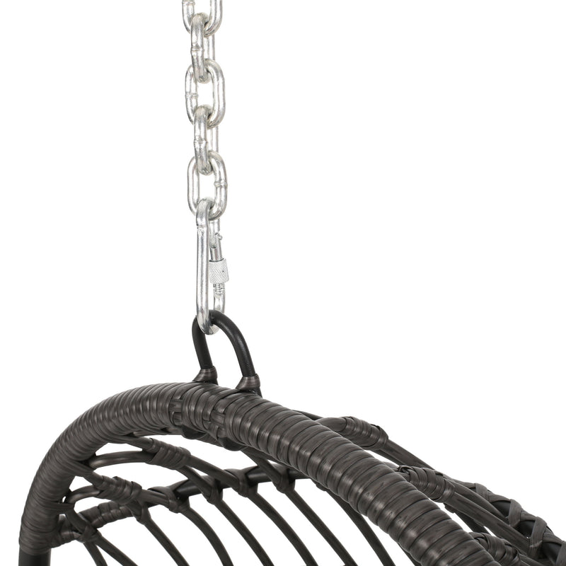 Rustic hanging basket chair with cushion from Noble House, featuring woven rattan design and soft fabric cushion for outdoor relaxation.